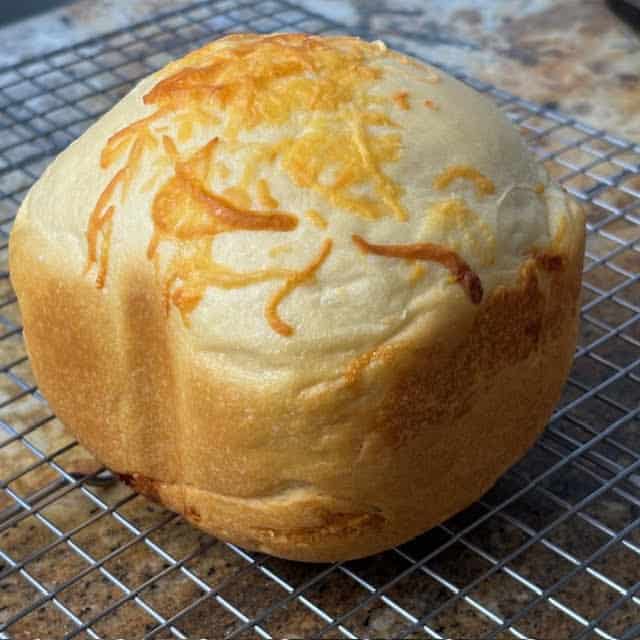 1 lb bread machine cheese bread on wire cooling rack.