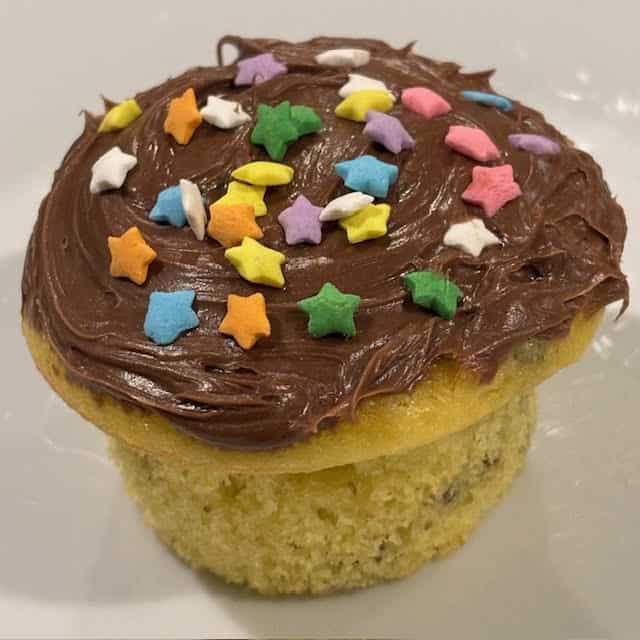 Cake mix cupcakes with sprinkles on white plate.