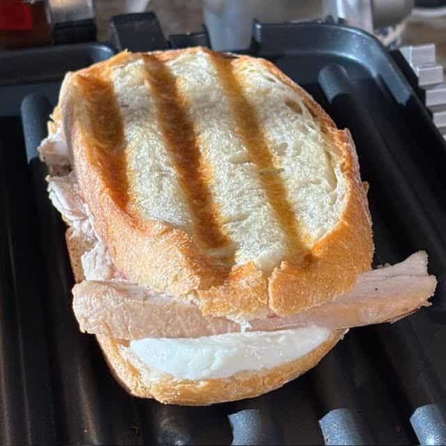 Turkey panini on a panini press.