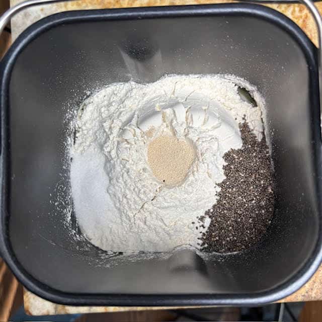 Ingredients for chia seed bread in a bread machine pan.
