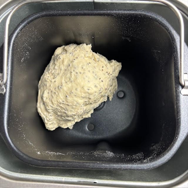 Dough for chia seed bread in bread machine pan.