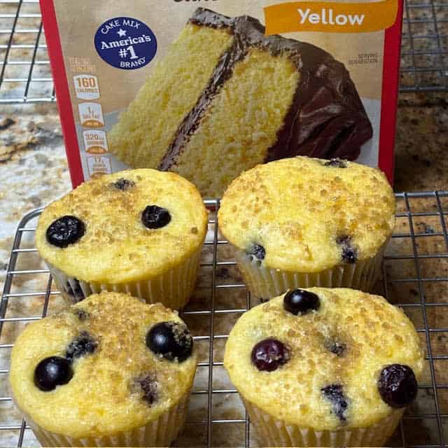 Blueberry cake mix muffins on wire cooling rack.