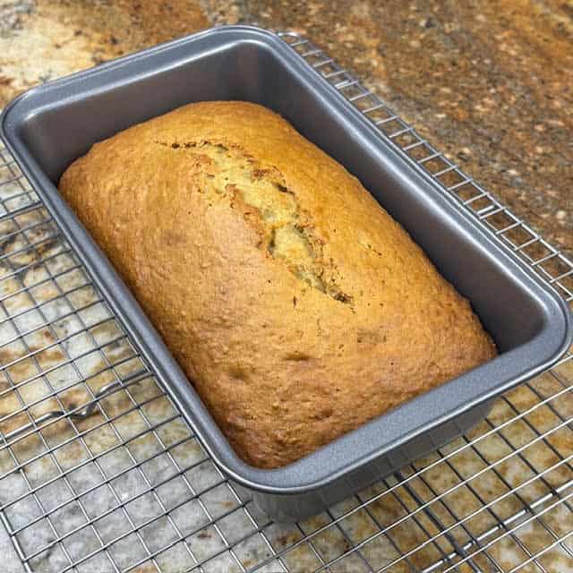 Carrot banana bread on a wire cooling rack.