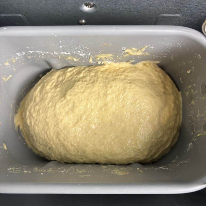Gluten free bread dough in a bread machine bread pan.