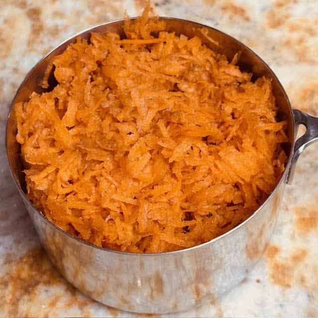 Cup of grated carrots for the carrot banana bread.