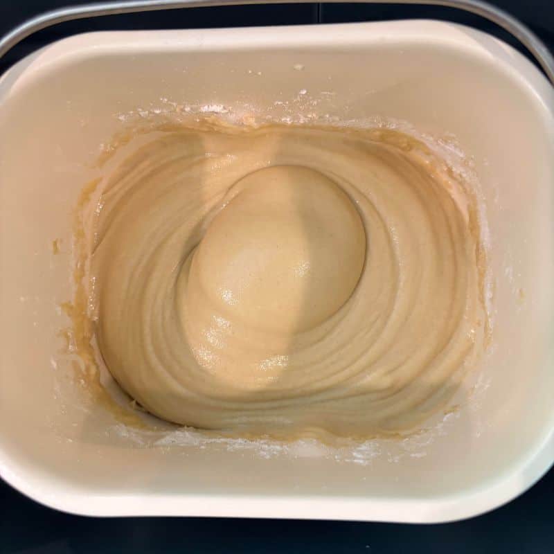 Gluten free bread dough in a bread machine bread pan.