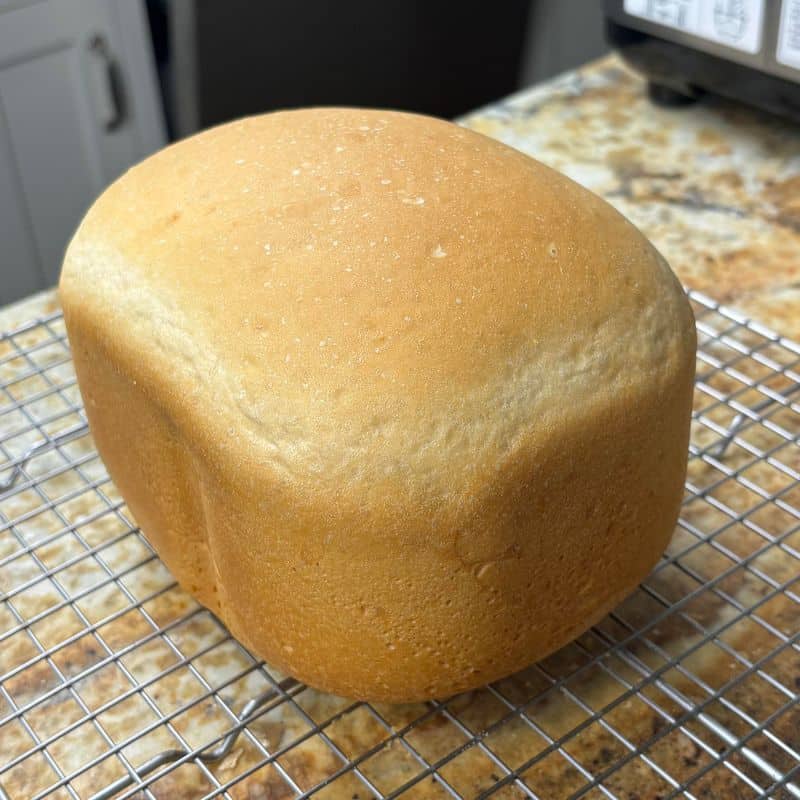 A loaf of my low salt bread machine recipe on a wire cooling rack.