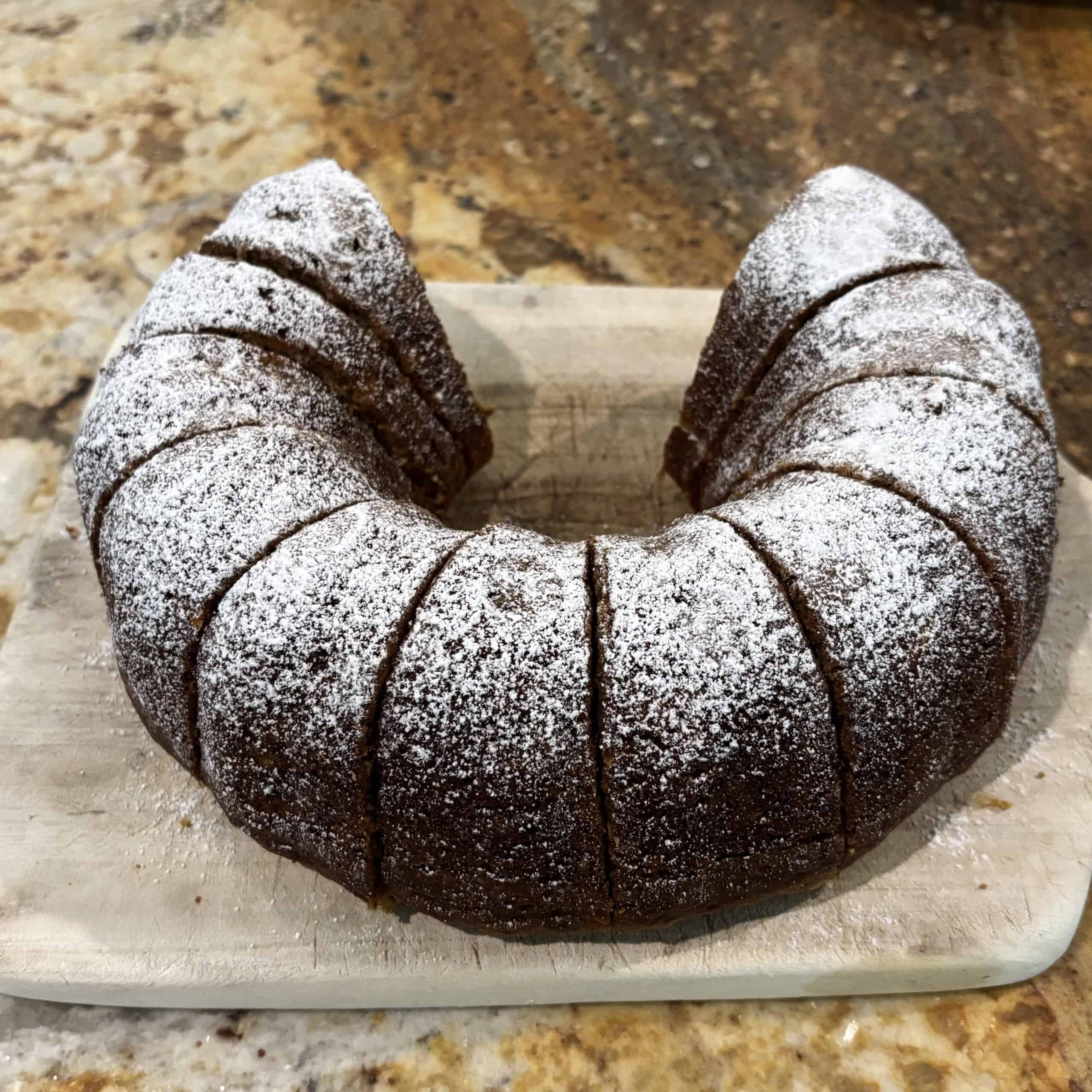 Slices of a Bundt banana bread recipe on a wooden cutting board.