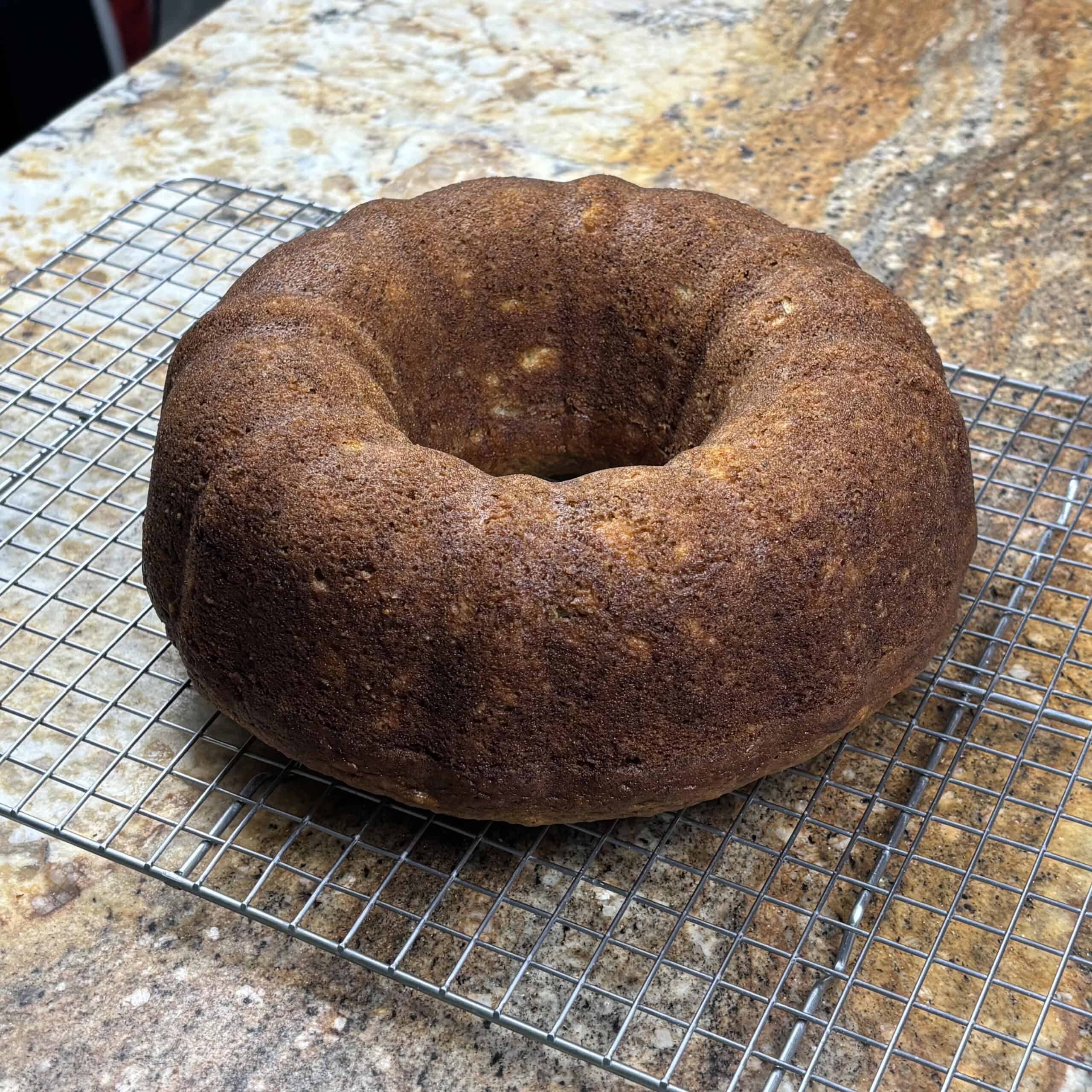 Loaf of a Bundt banana bread recipe on a wire cooling rack.