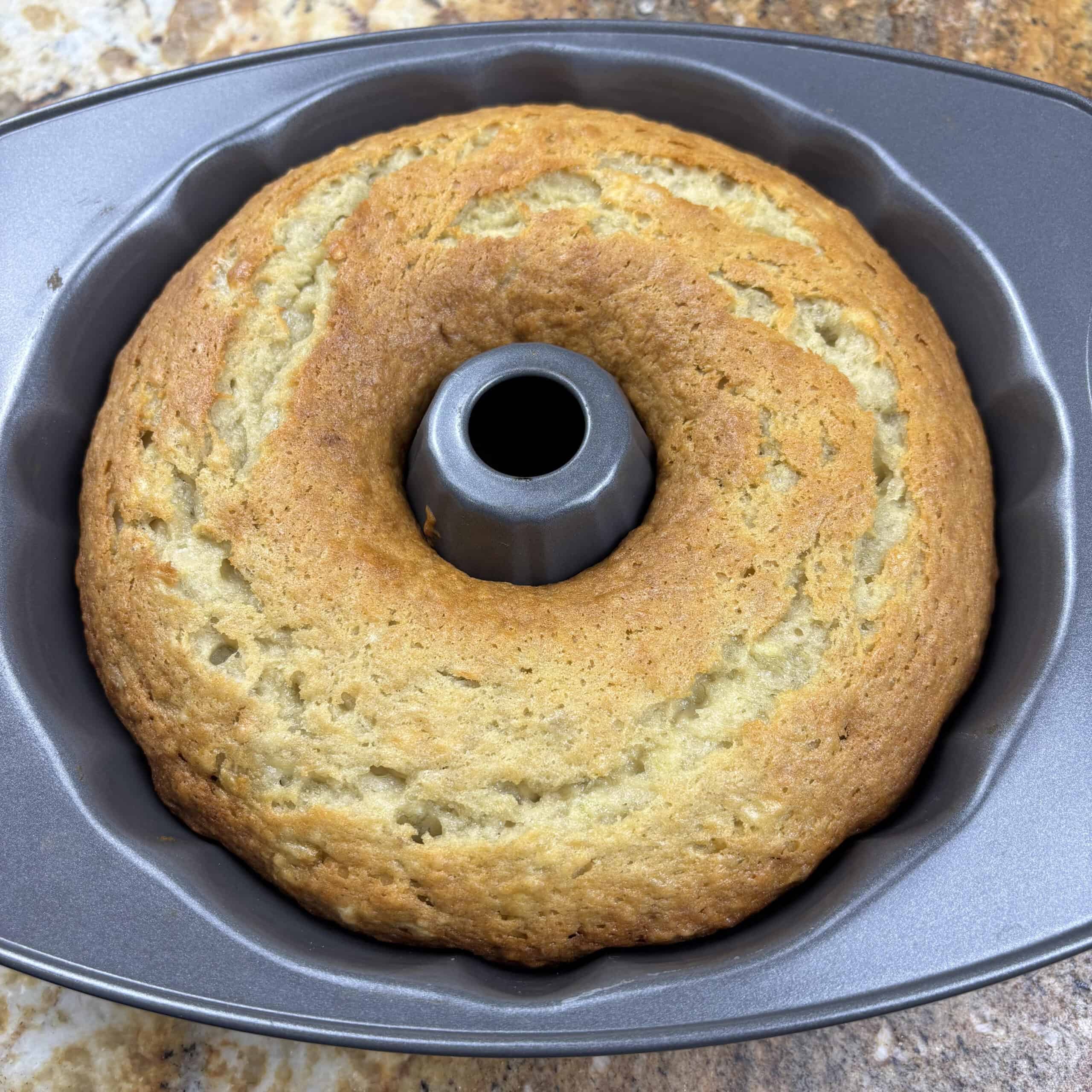 Banana bread Bundt cake in Bundt pan on kitchen counter,