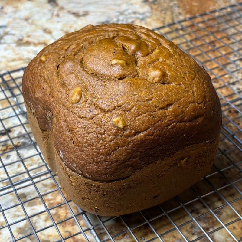 Bread machine pumpkin bread on a wire cooling rack.